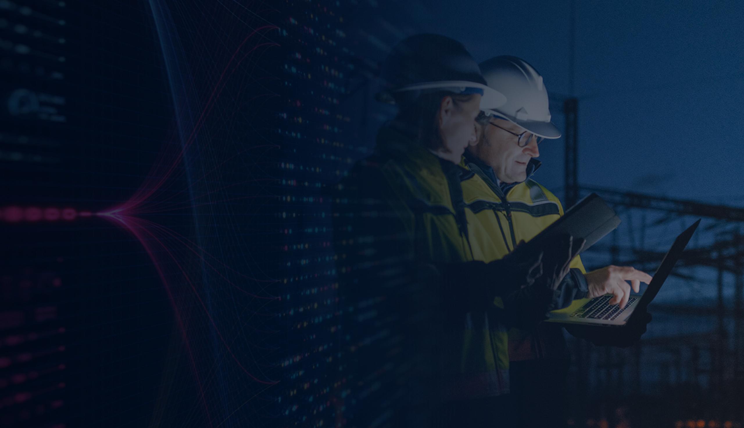 Two ICS Workers Look at a Laptop