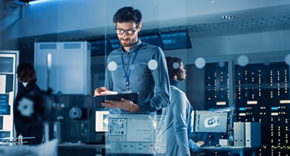 Man In A Control Room Using A Tablet