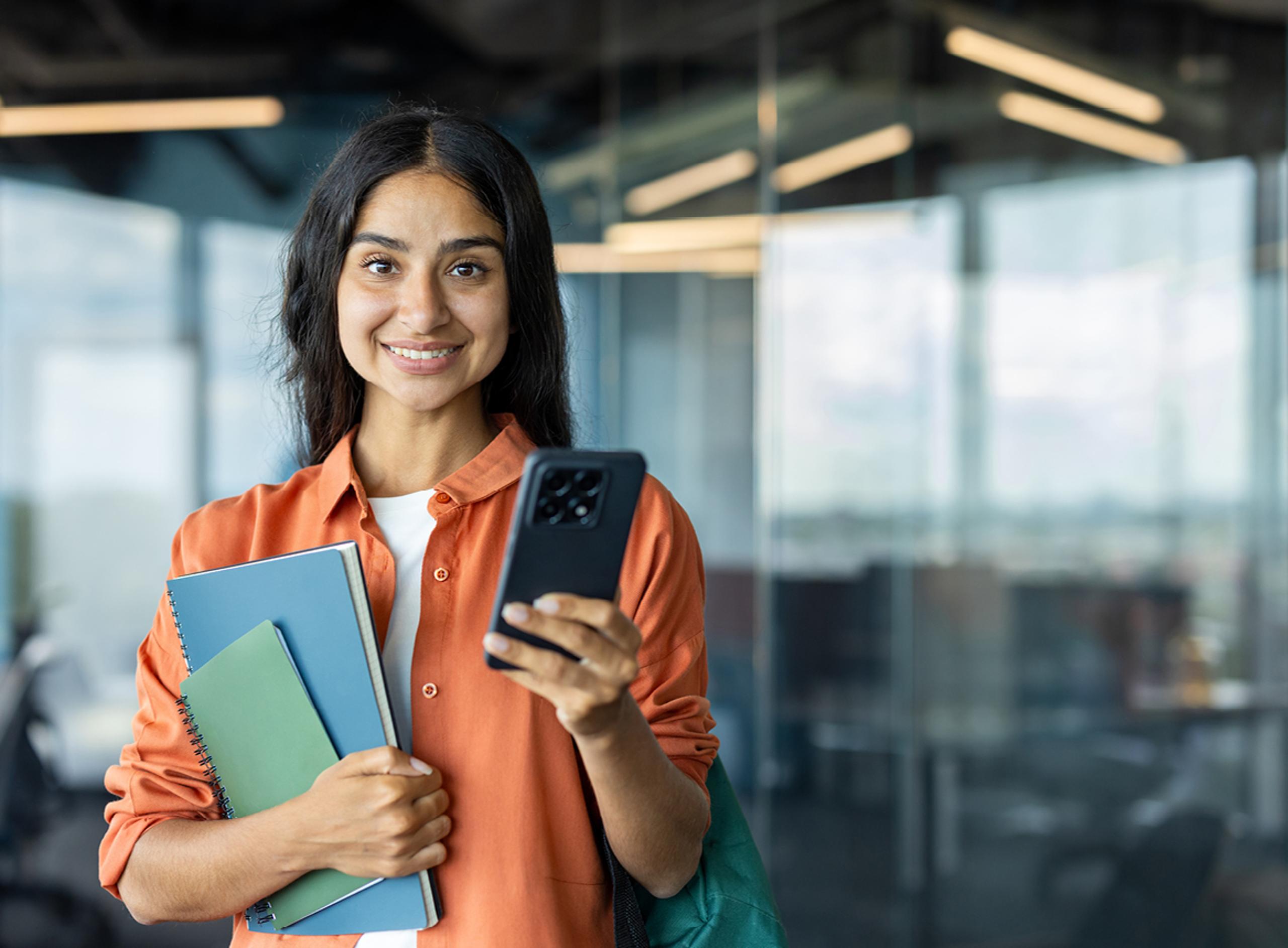 Woman in Orange Holding Phone