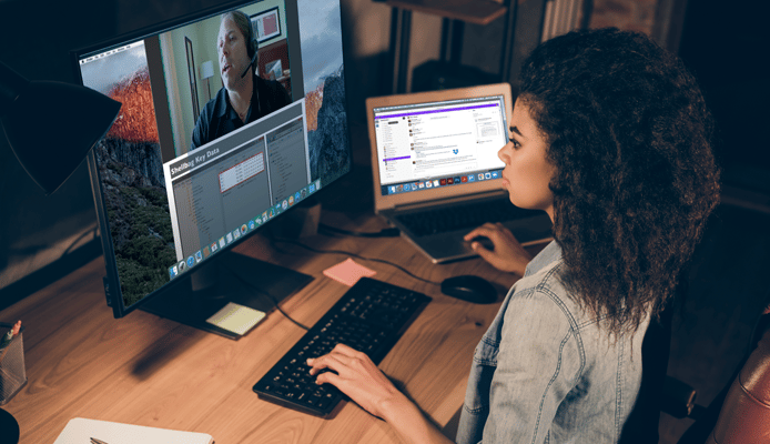Woman at Desk at Home Listening to an Ondemand Course