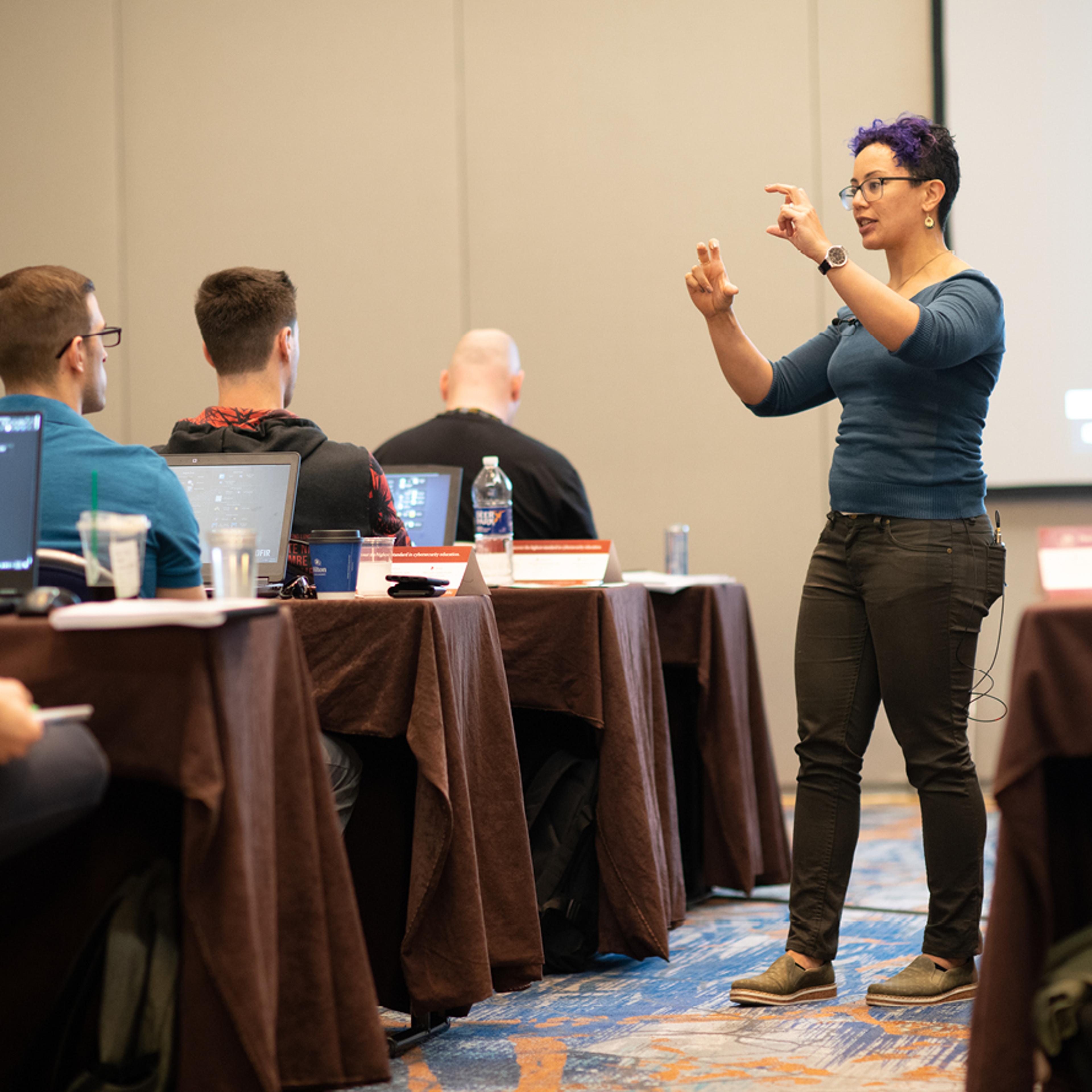 Lodrina Cherne: A Teacher Explaining A Concept in A Classroom