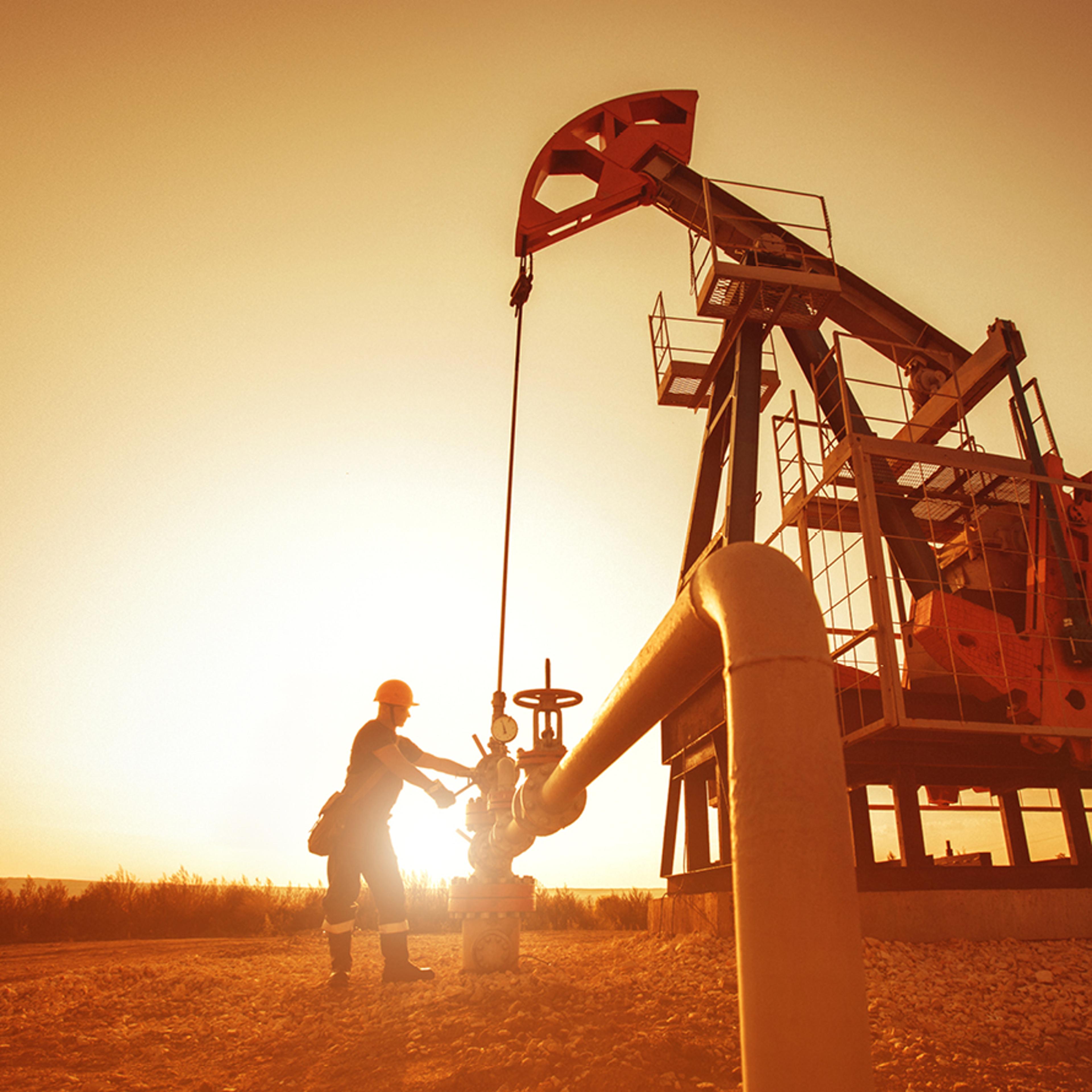 Man Operating a Drill at Dusk