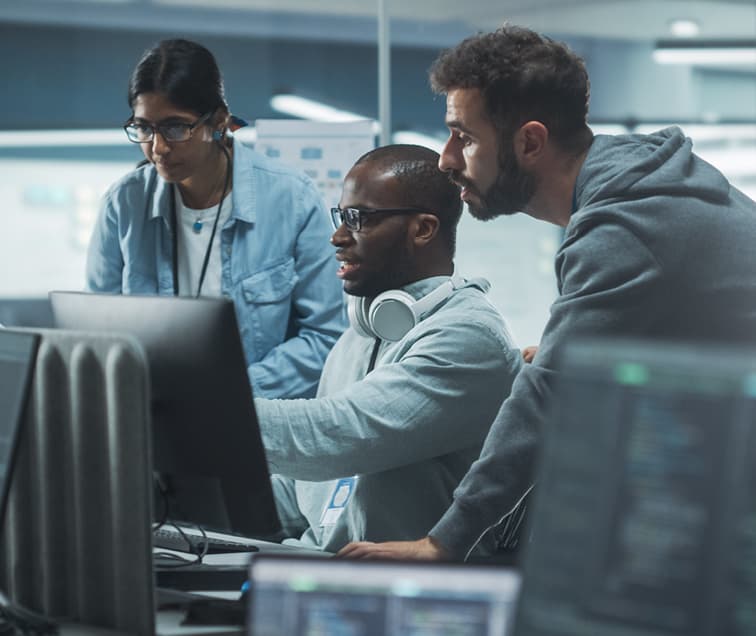 Three People in High Tech Office Looking at a Computer
