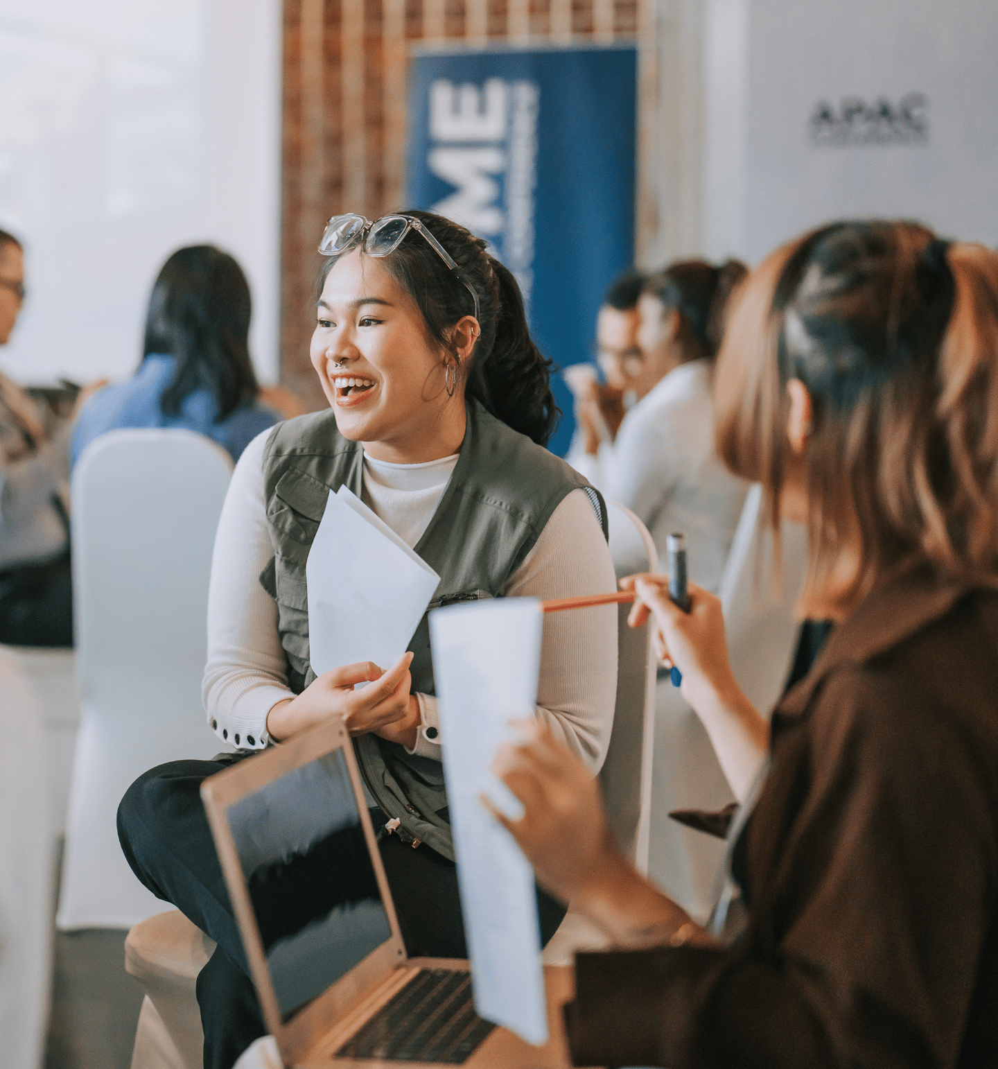 Woman Smiling in an APAC Event Room