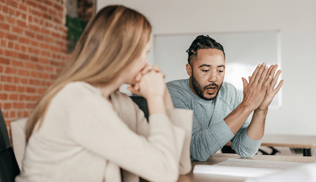 Two Coworkers Speaking in an Office