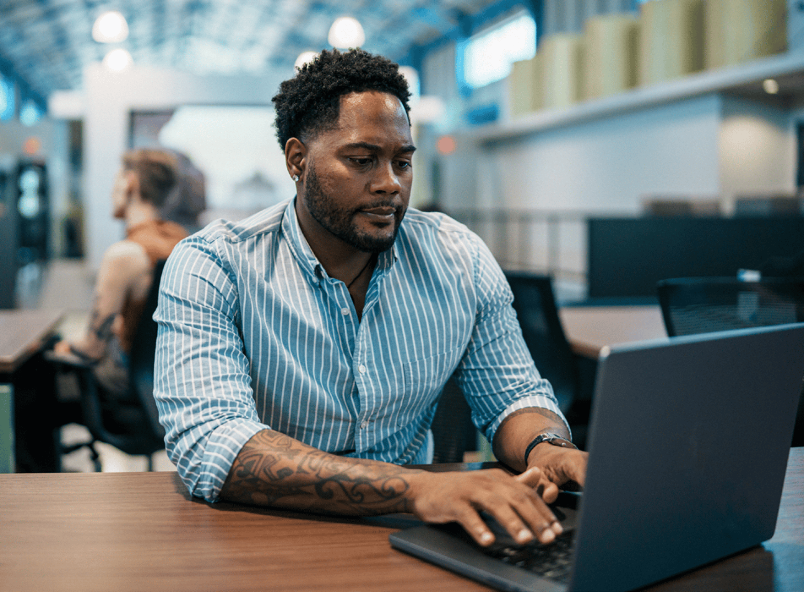 Man Concentrating and Typing on Laptop