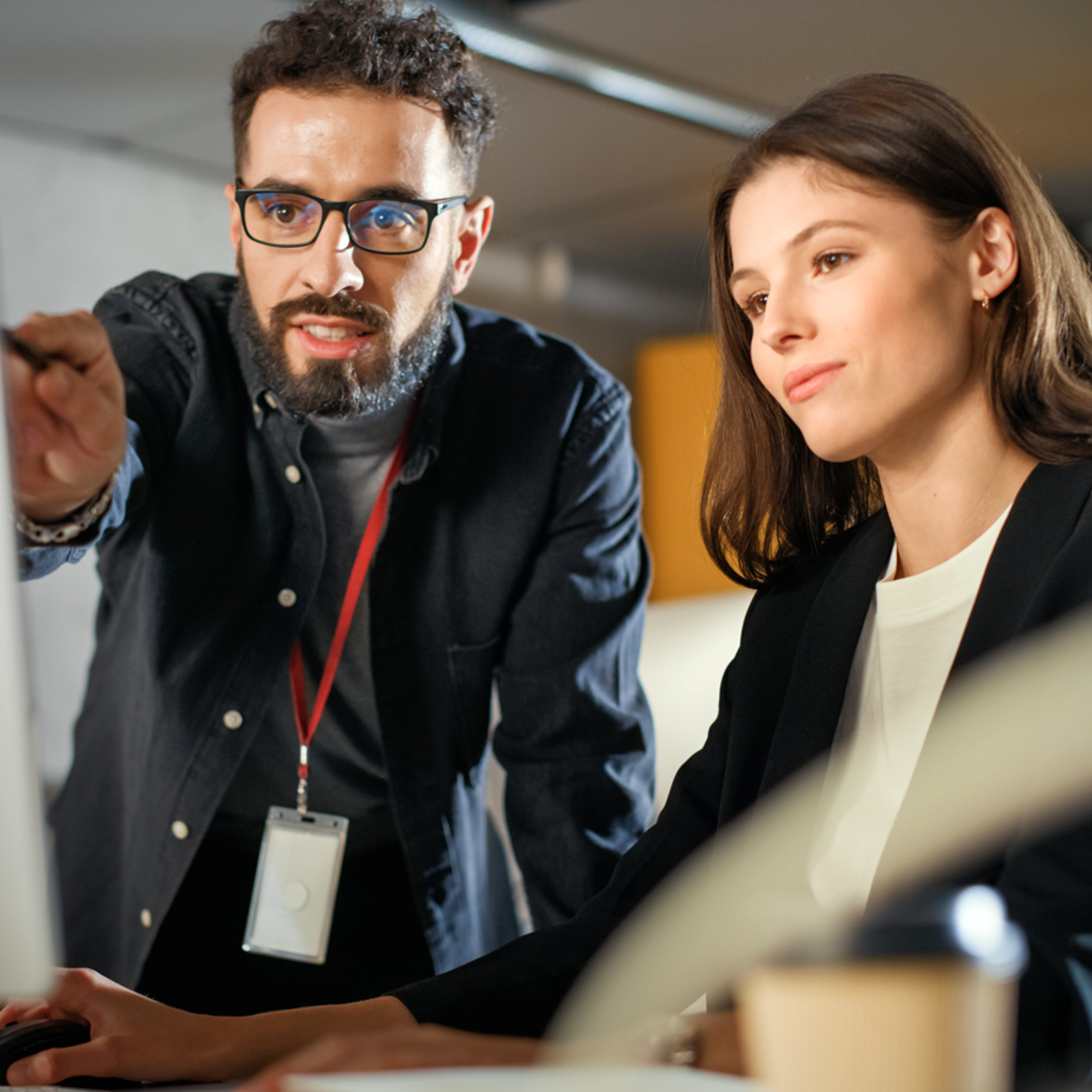 Man Pointing and Woman Looking Thoughtful