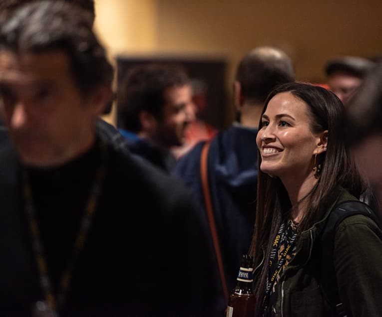 Woman Smiling While Attending a Summit