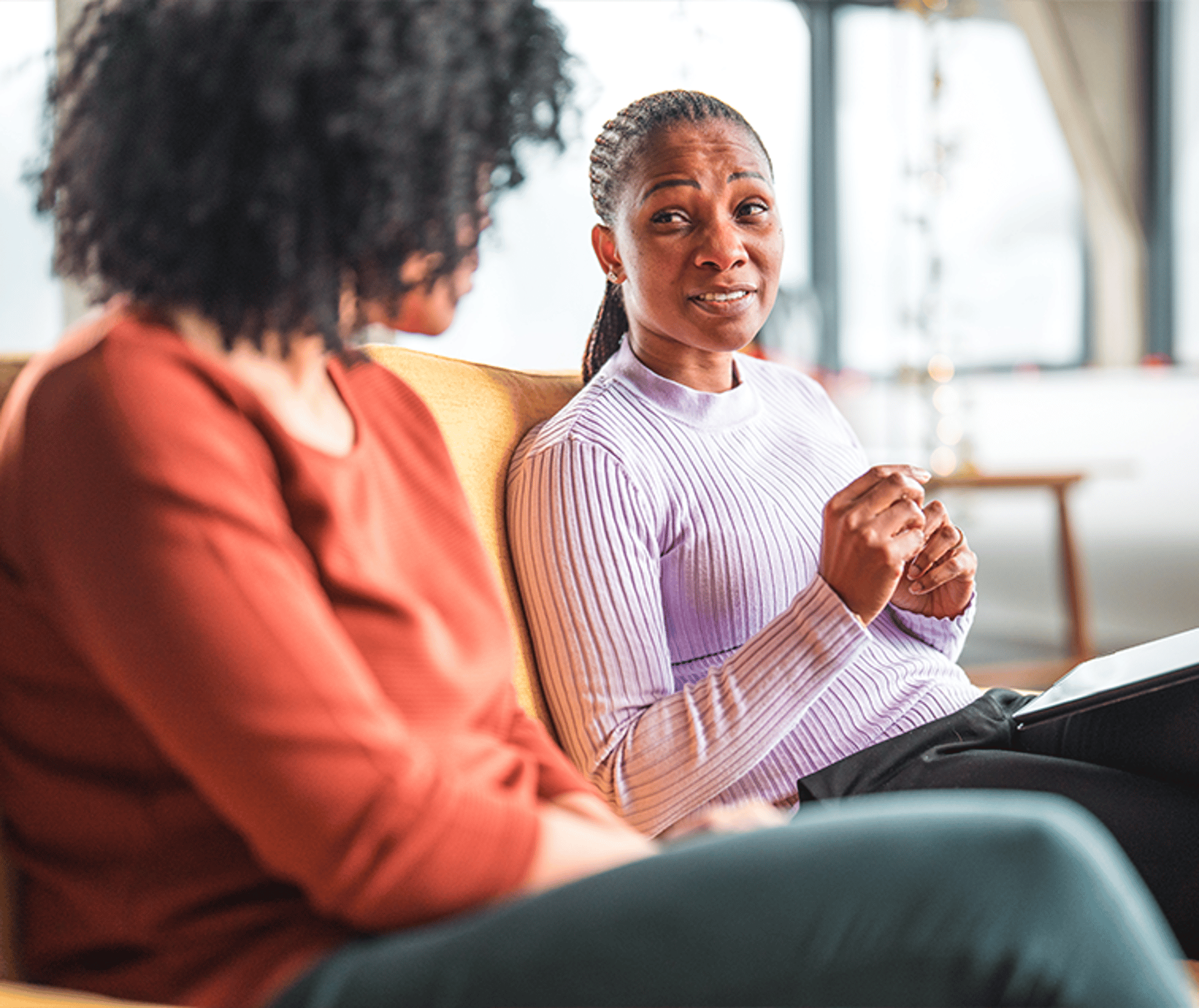 Two Women Talking on a Sofa