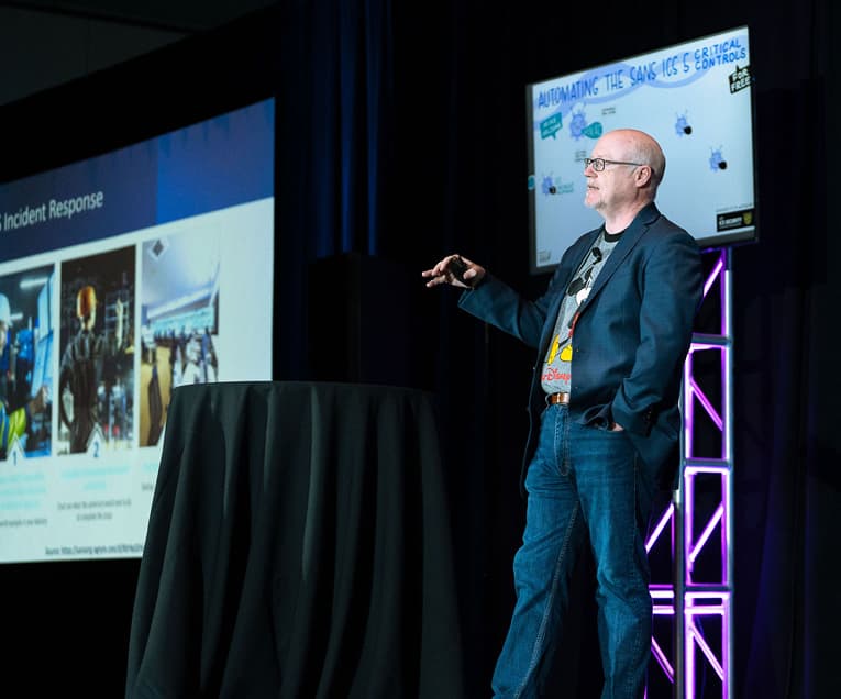 SANS ICS Security Summit 2026: Men Giving a Presentation on Stage