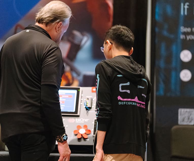 SANS ICS Security Summit 2026: Two People Collaborating On a Project