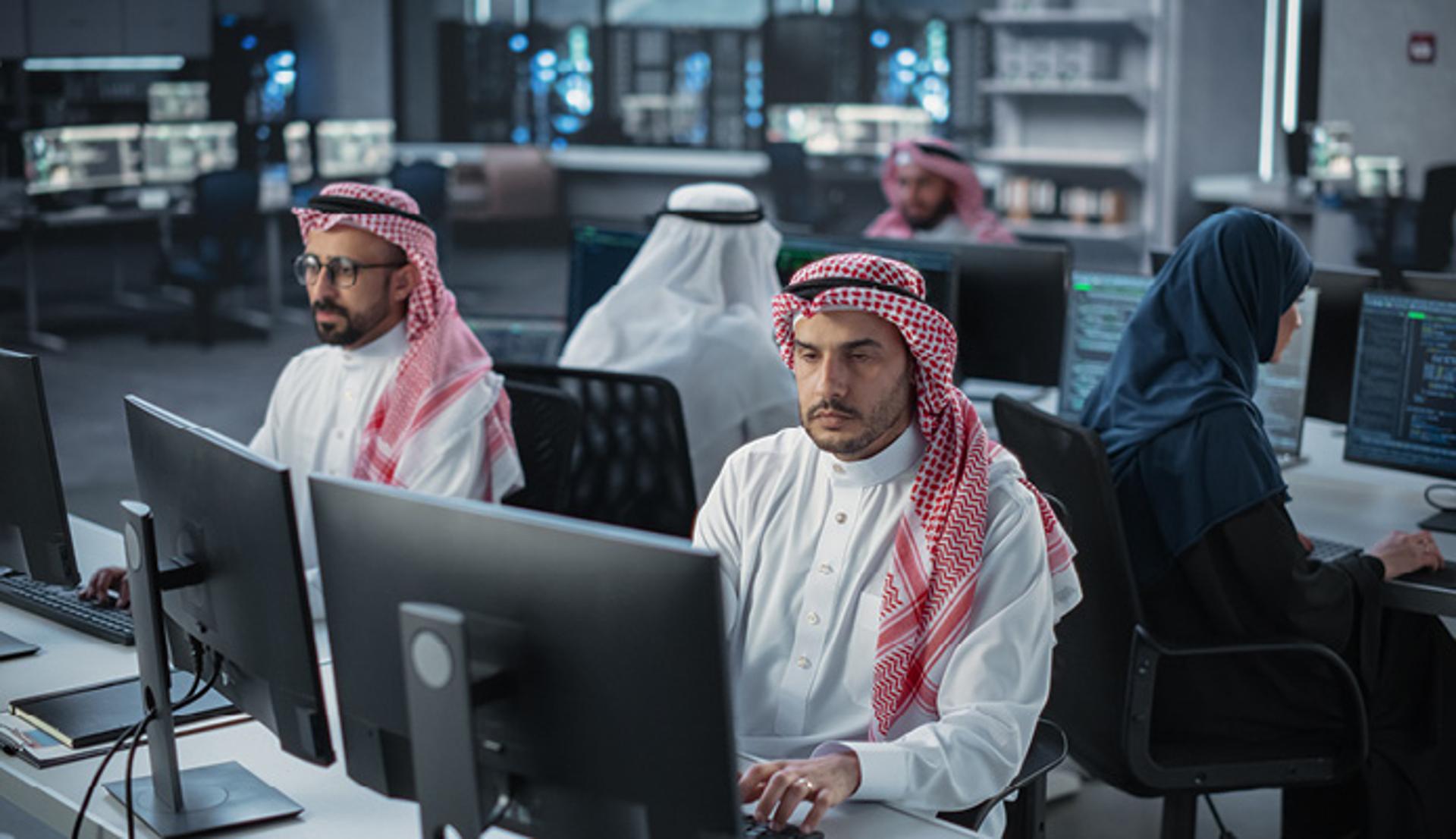 Men working on computers in an office