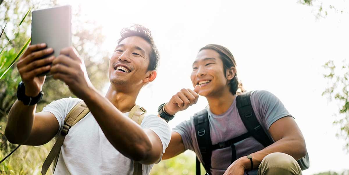 Two male friends reading a giant list of Chinese adjectives.