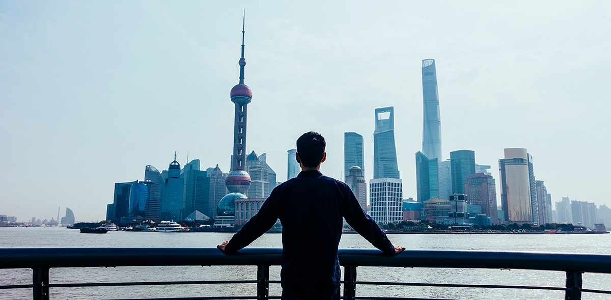 Man looking at the buildings and skyline of Shanghai China.