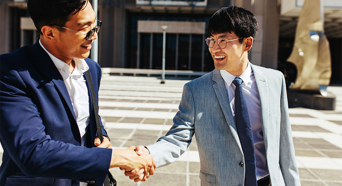 Two men shaking hands after making a transaction.