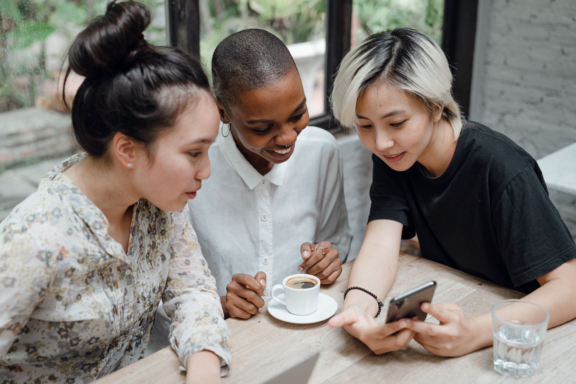 Diverse employees looking at mobile phone