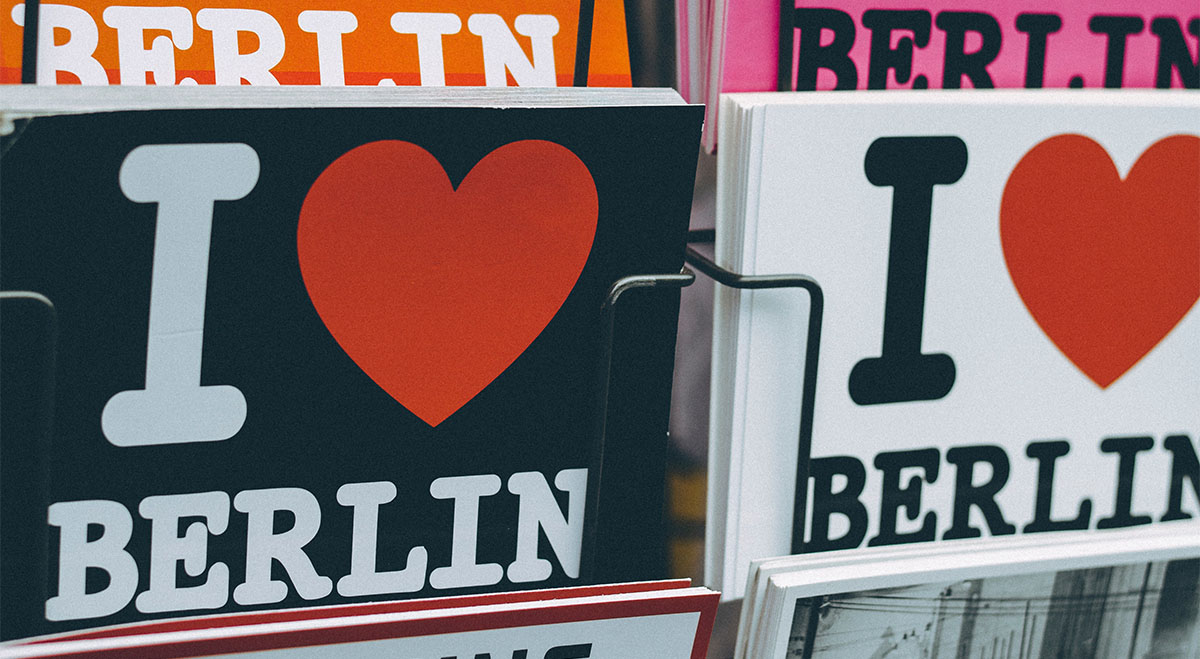 Write a postcard from Berlin to friends and family.