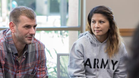 Adults participating in a group discussion session, symbolizing community-based Greek language courses for adult learners.