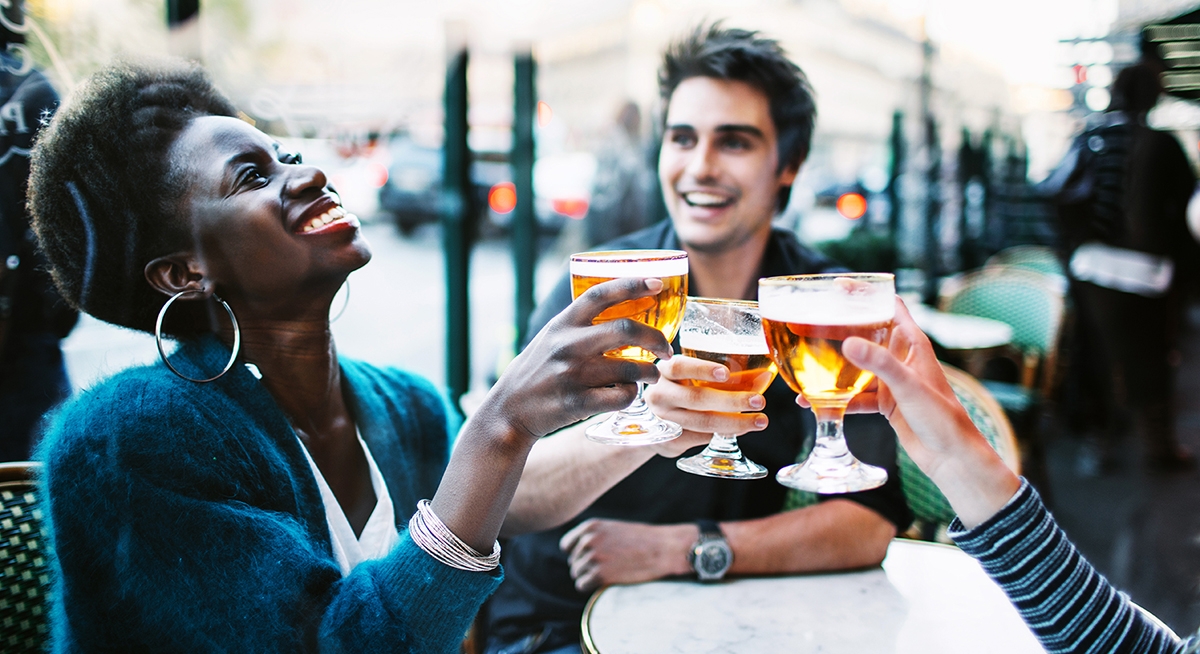 Friends meet for a drink in Brazil and say hello in Portuguese.