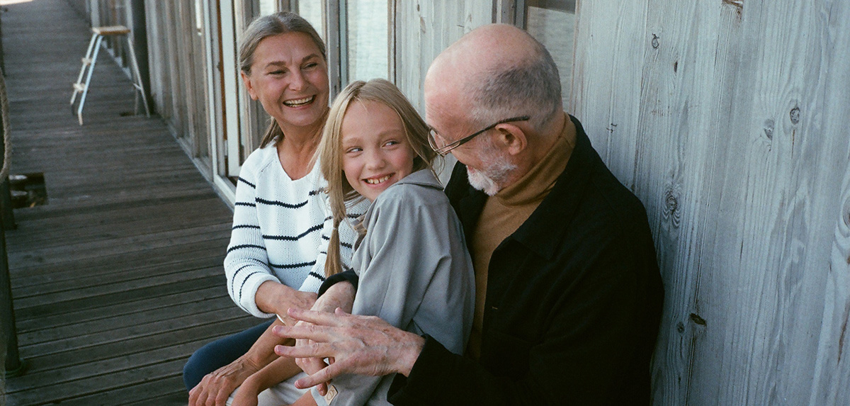 Young girl with her grandparents in Italian.