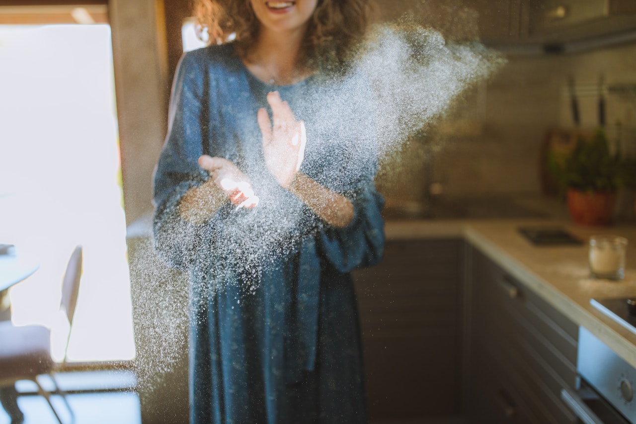 Happy woman displaying a hand clapping gesture, a symbol of embodied learning