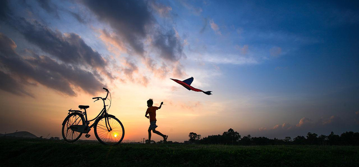 Boy flying a kite.