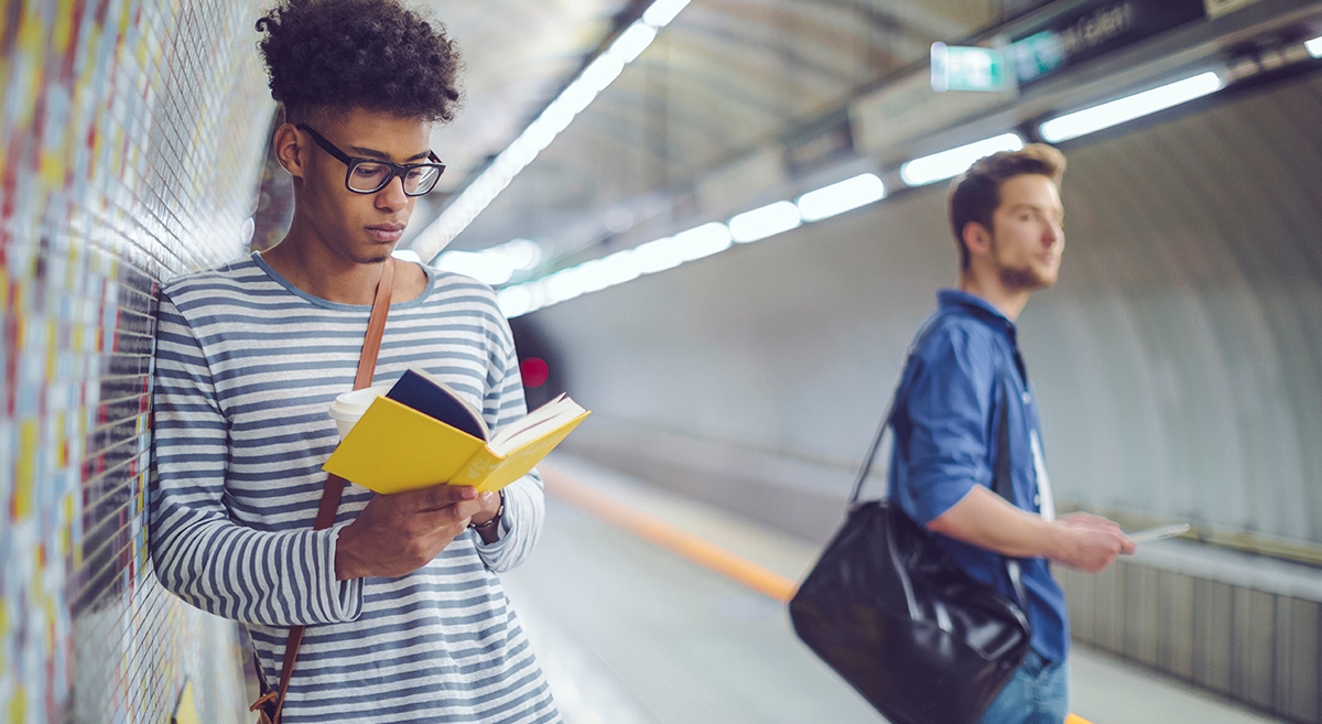 Man studies Italian with Berlitz while commuting to work, showcasing an idea for how to learn a language fast.