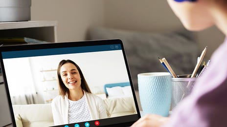 Student attending interactive online French group classes through a video call on her laptop
