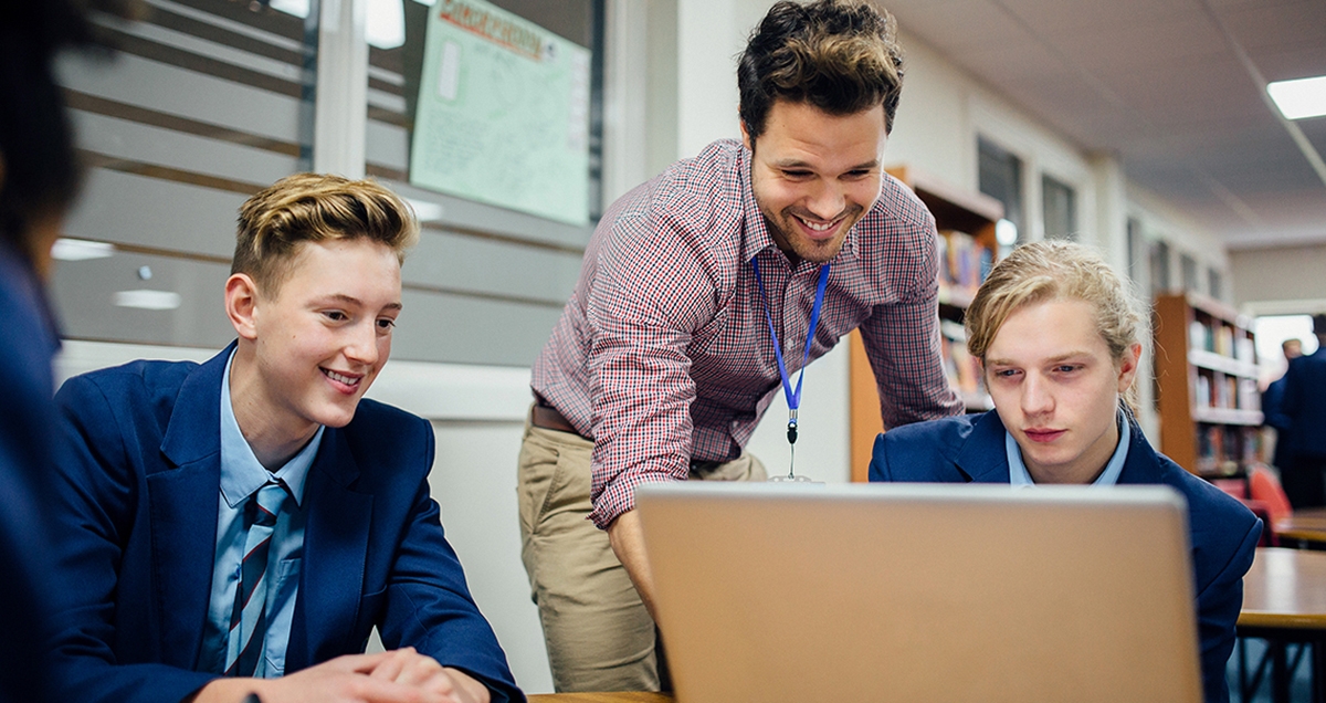 Teen boys learning to code during a math class.