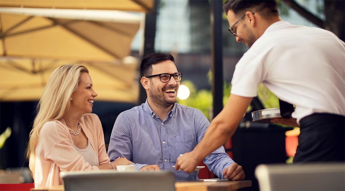 Couple ordering food in a French cafe.