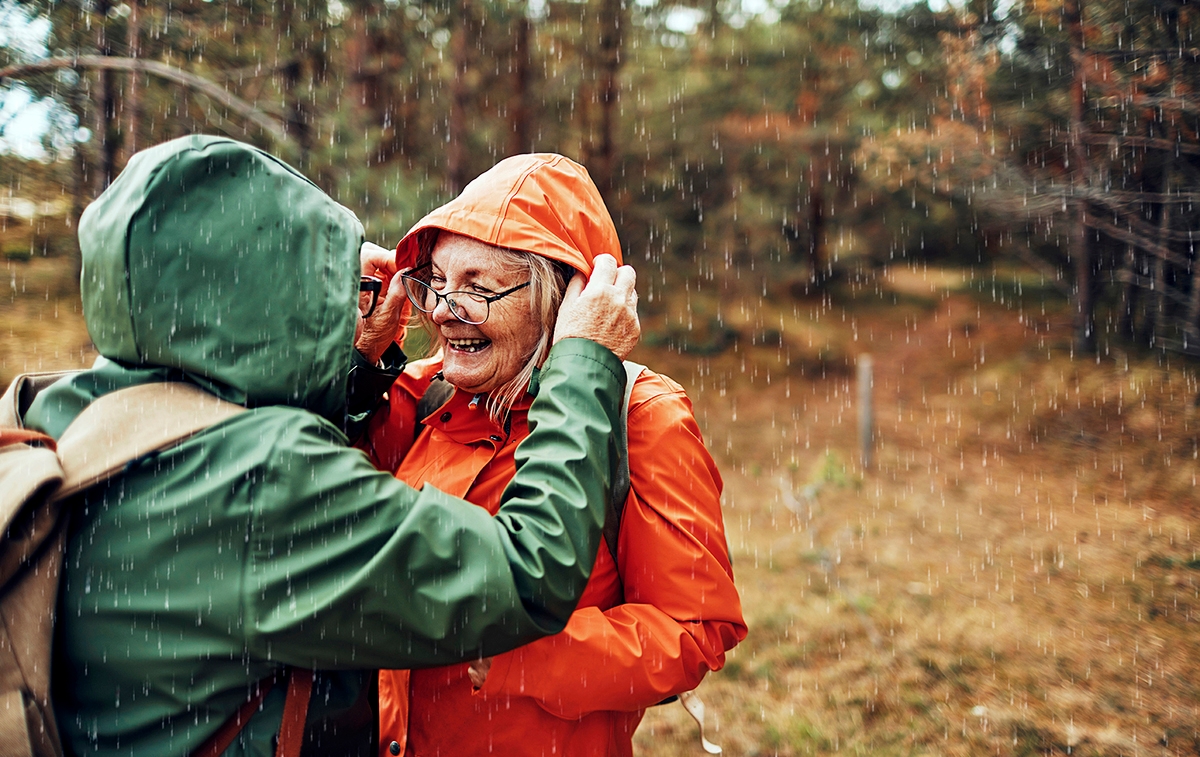 Woman saying thank you in French to her friend when they get caught in the rain.