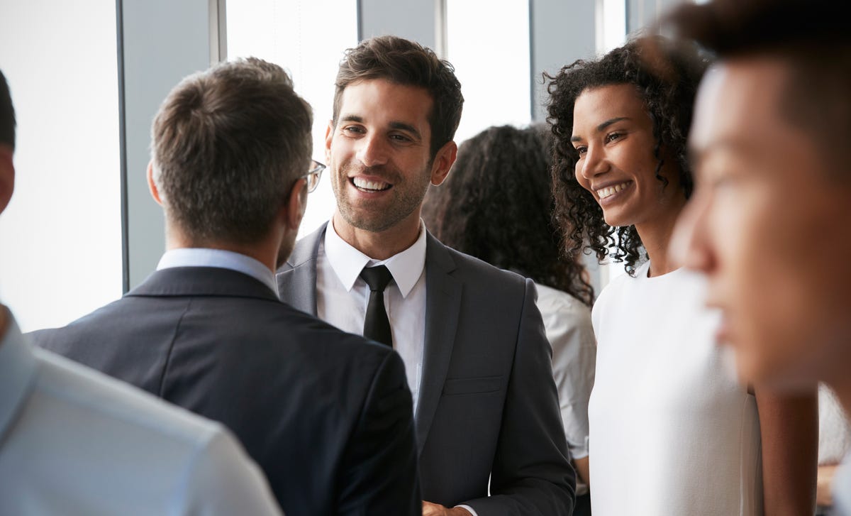 Professionals networking at an event, representing diverse learners interested to learn Bulgarian for business communication.