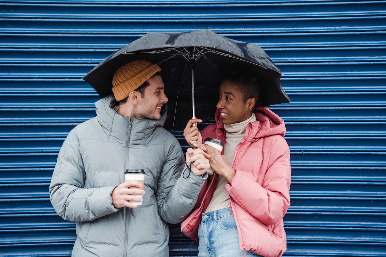 Two people sharing an umbrella.