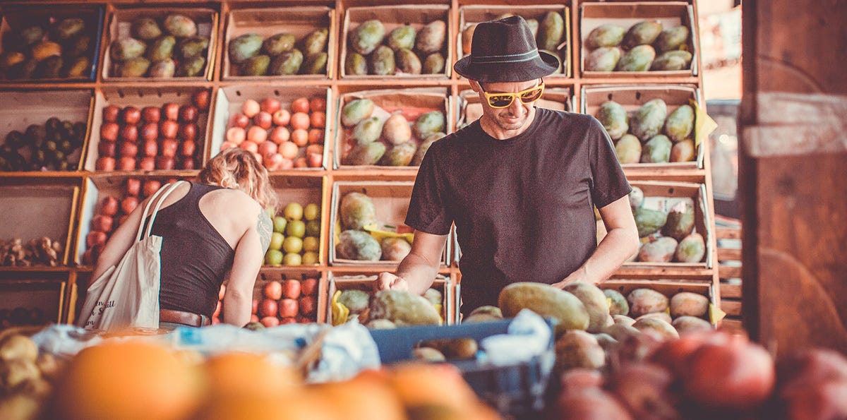 Man shopping at a market for fruit in Germany.