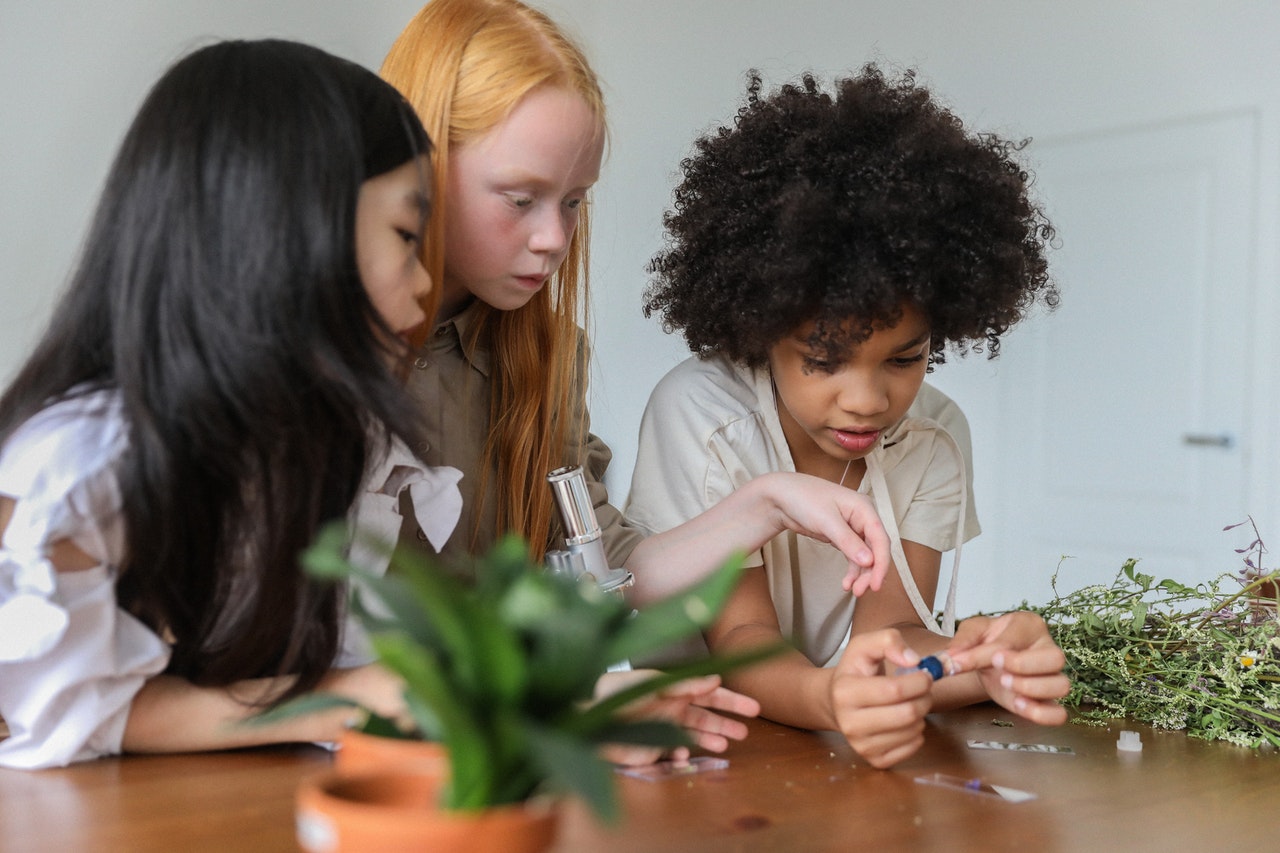 The benefits of learning sign language show as these children perceive the visual information during a science experiment.