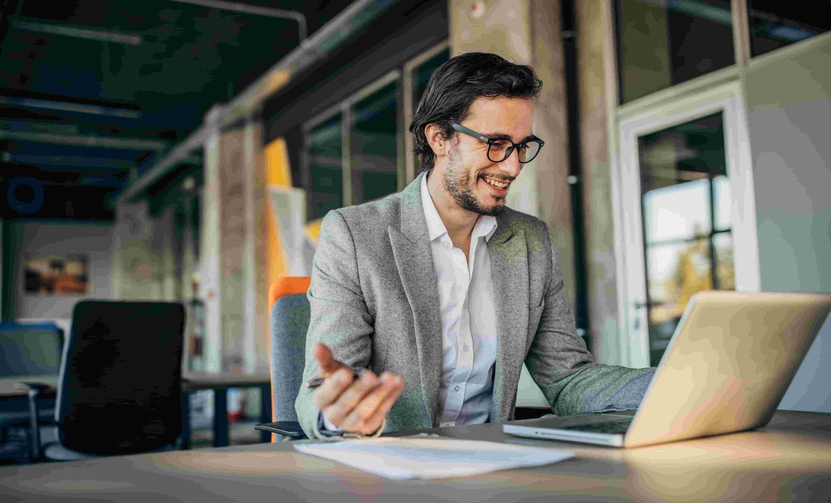 Smiling professional conducting a virtual session, representing Berlitz opportunities for those seeking teach English online jobs from anywhere.