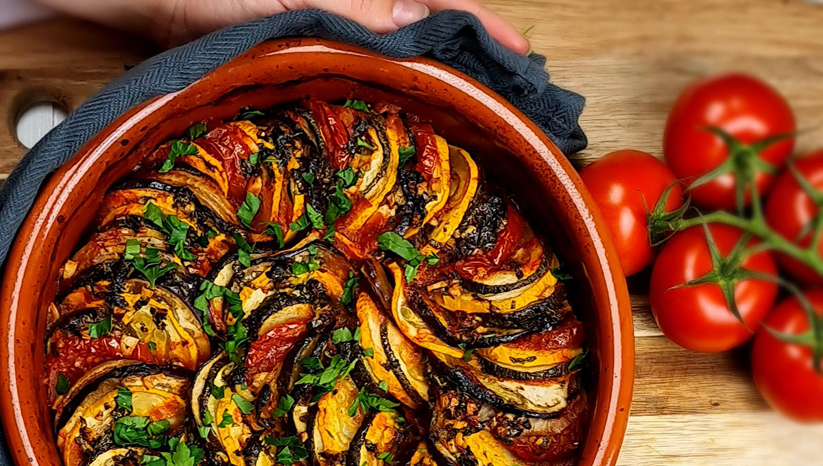 Ratatouille is a vegetable medley stew featuring eggplant, zucchini, peppers, and tomatoes.