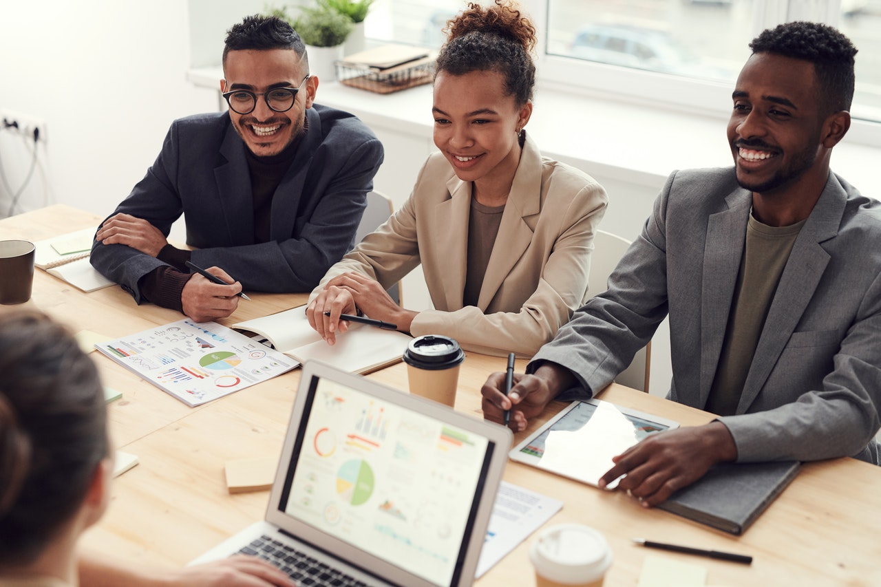 Happy_colleagues_meetings_Diverse and happy colleagues meeting about eliminating unconscious interview biasabout_setting_diversity_goals.jpg