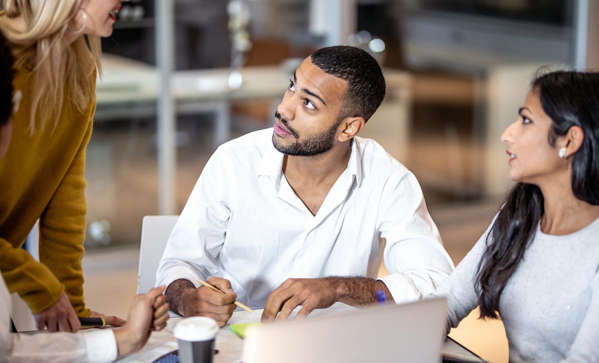 Focused multicultural team discussing during an online Farsi language lesson