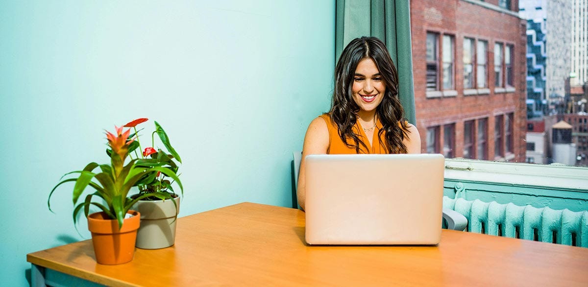 Woman follows the easy Spanish verb conjugation guide by Berlitz.