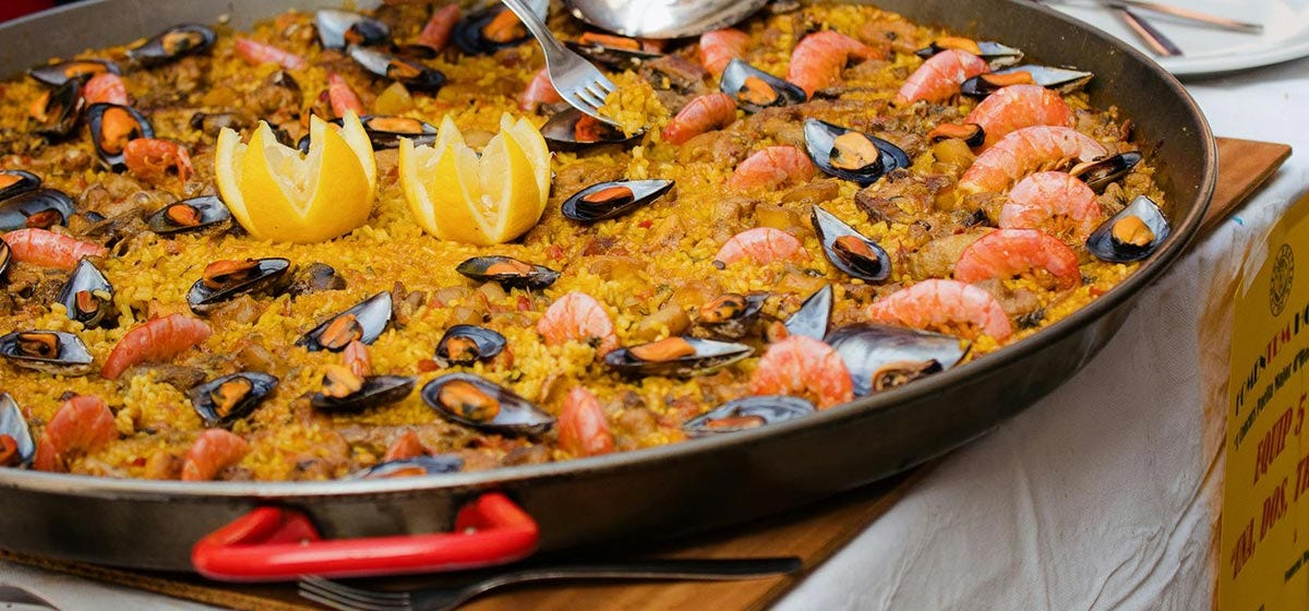 Paella is a rice dish made with saffron, various meats and seafood.