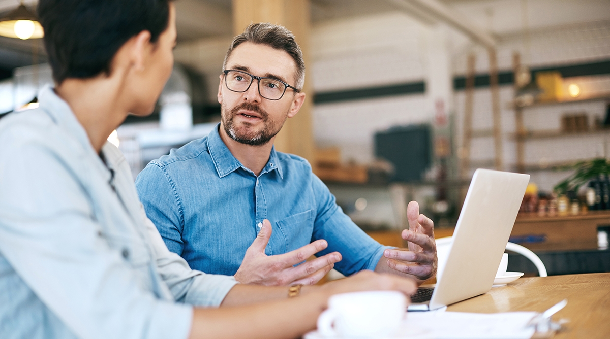 Man says sorry in French to his colleague at work, in a formal business environment.