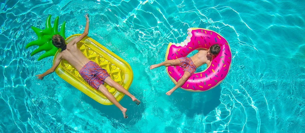 Kids swimming in a pool.