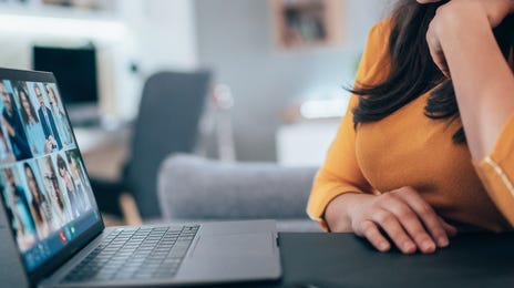 Smiling woman participating in a virtual class to learn Romanian online through group video call