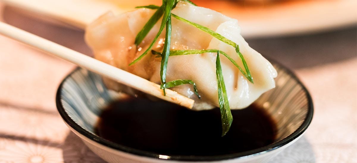 Dipping a dumpling into soy sauce.