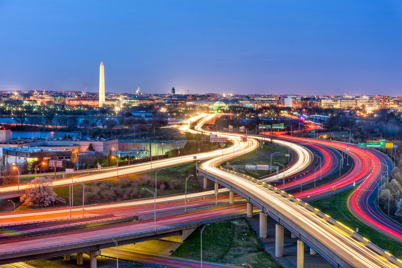 Evening view of Washington D.C. with highways leading toward the National Mall, symbolizing connectivity and access to language schools in the capital.