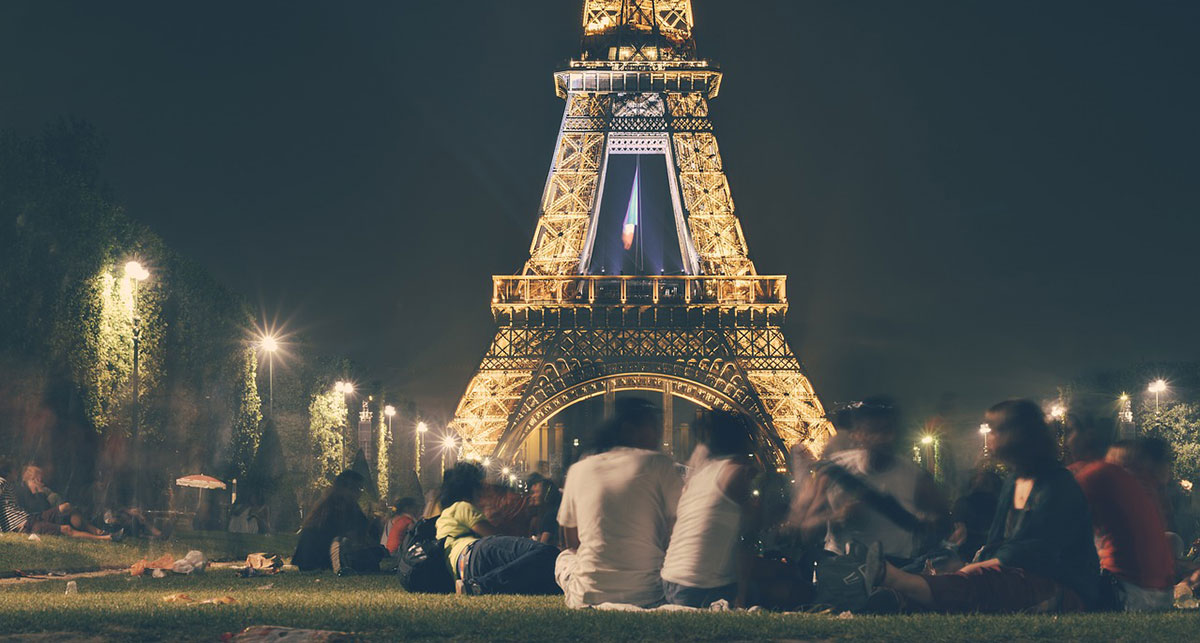 Locals having a picnic near the Eiffel Tower in Paris.