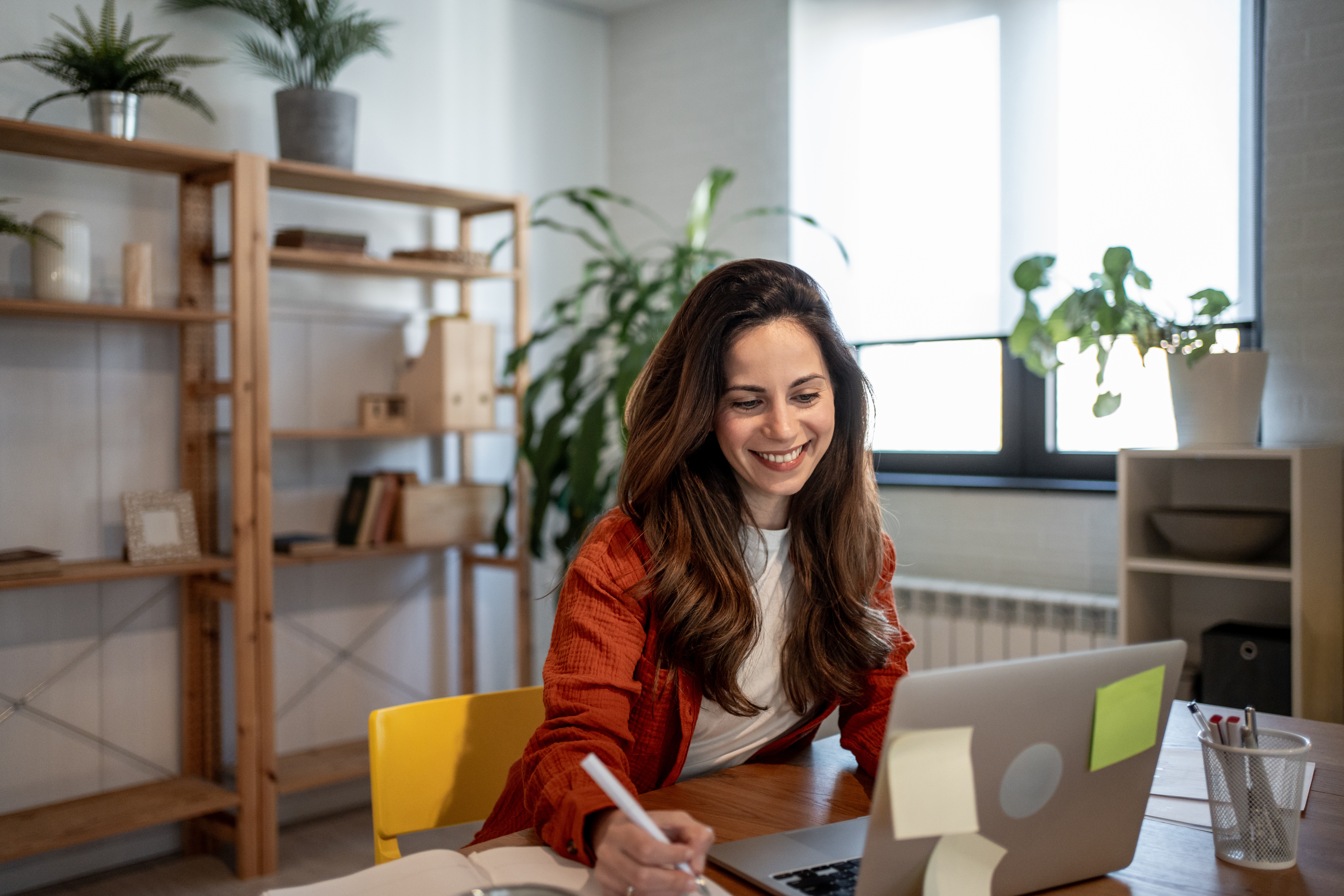 Woman in front of her laptop using AI responsibly during her work