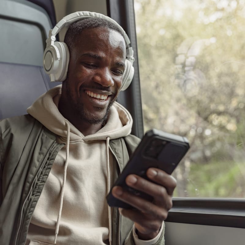 Man on train working on his phone