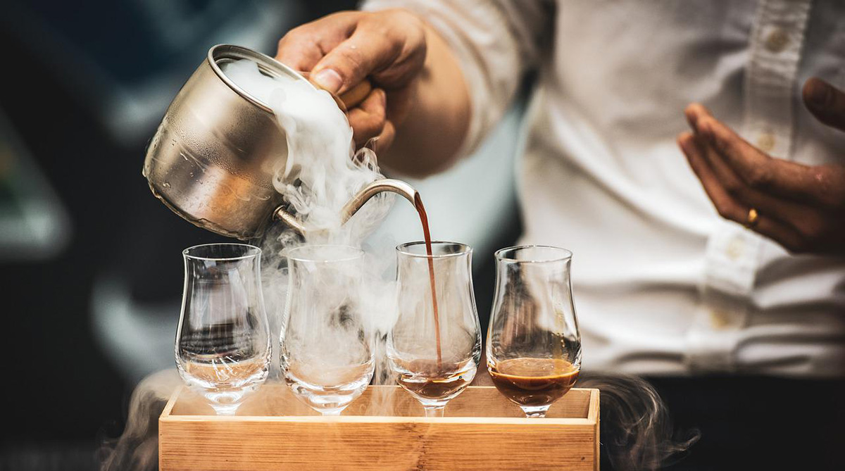 A barista serving coffee in Turkey.